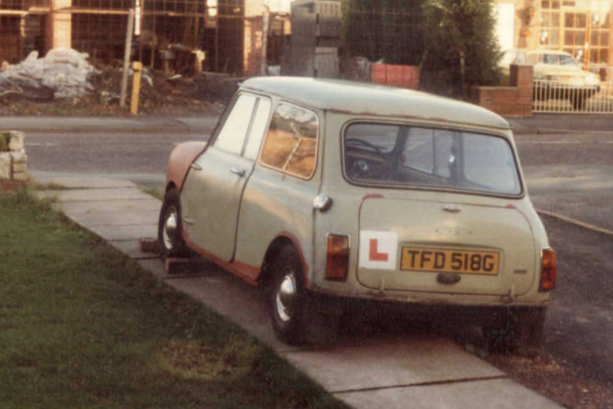 Mini Cooper driving through the snow.